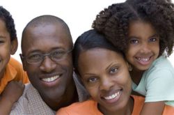 african parents smiling with their son and daughter