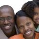 african parents smiling with their son and daughter