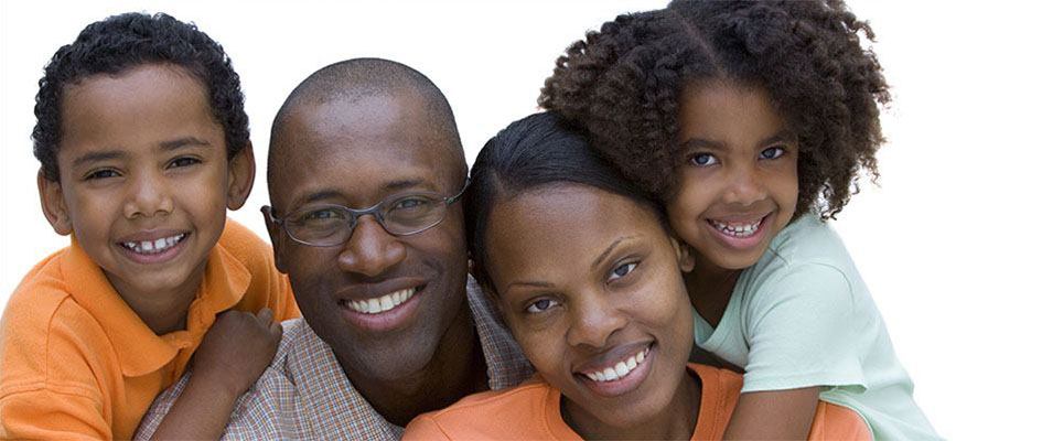 african parents smiling with their son and daughter