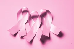 3 pink breast cancer ribbons with a pink background