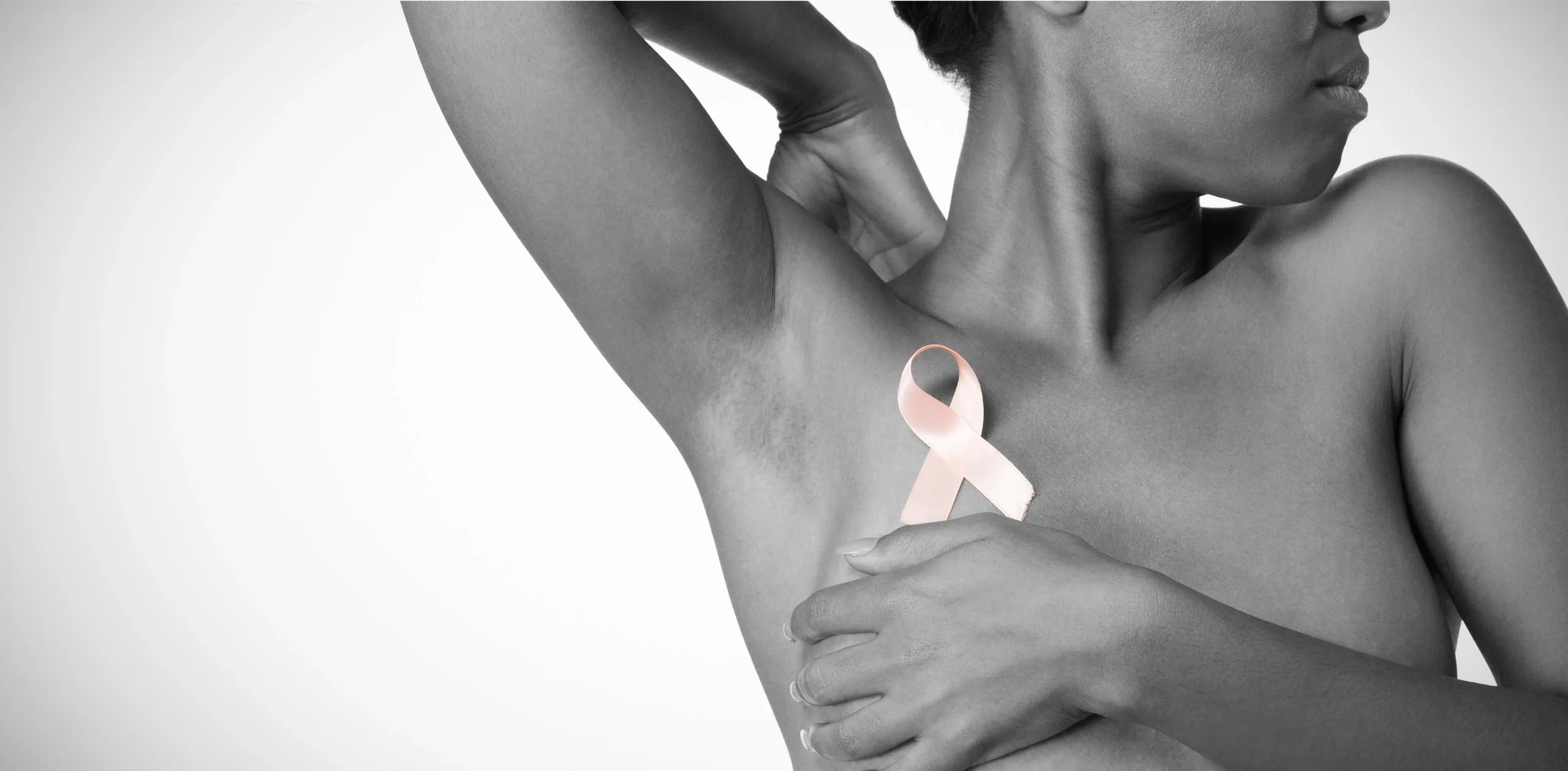 African woman holding pink breast cancer ribbon