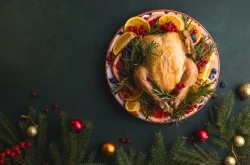 Roast Chicken served on a dish with Christmas decorations the table