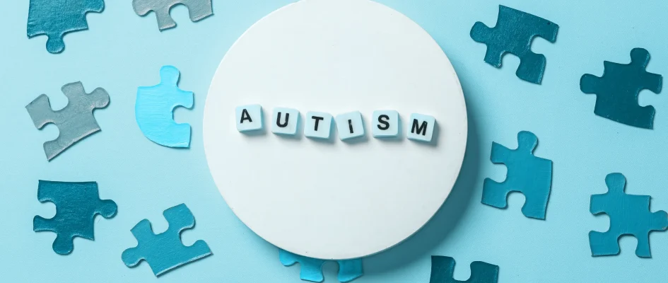 Autism words surrounded by puzzle pieces