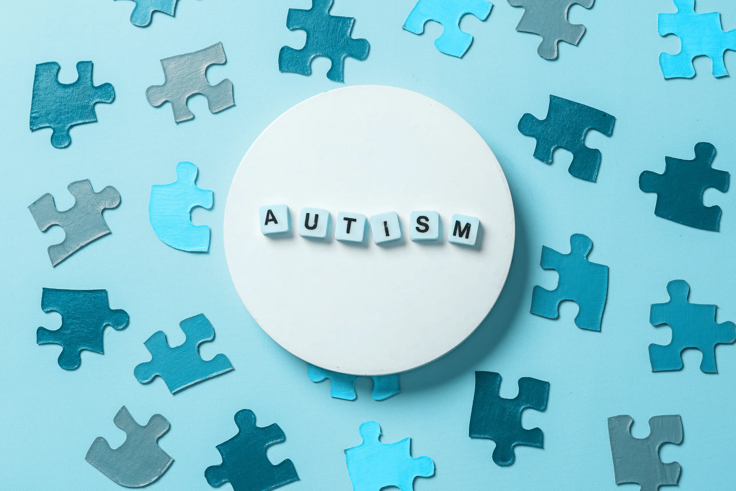 Autism words surrounded by puzzle pieces