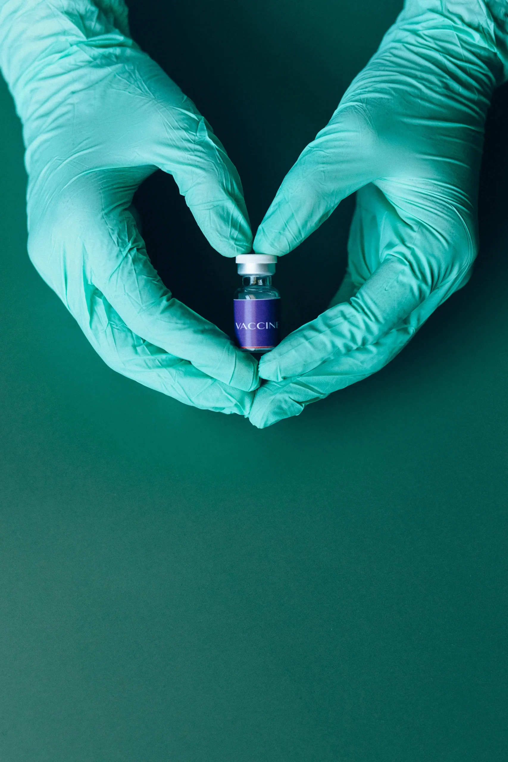 Doctor with nitrile gloves holding a vaccine vial