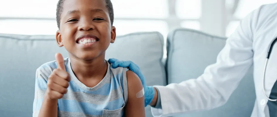 Young child at the doctors office smiling during consultation