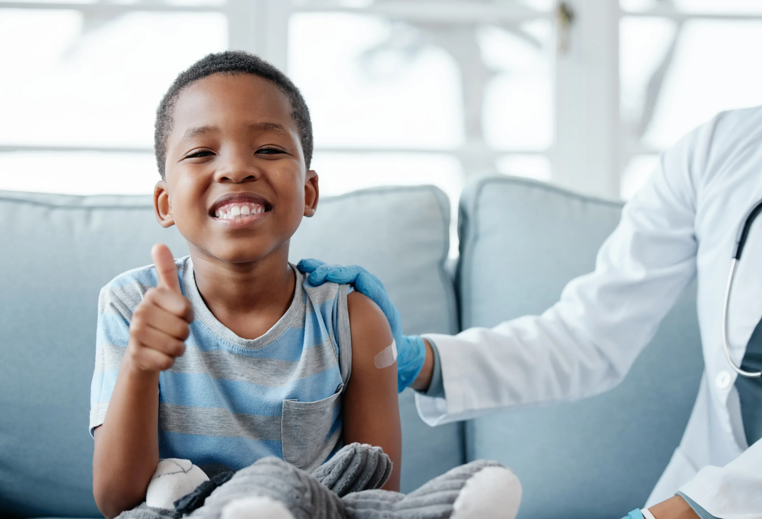 Young child at the doctors office smiling during consultation
