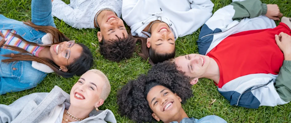 Group of young adults laying in a circle