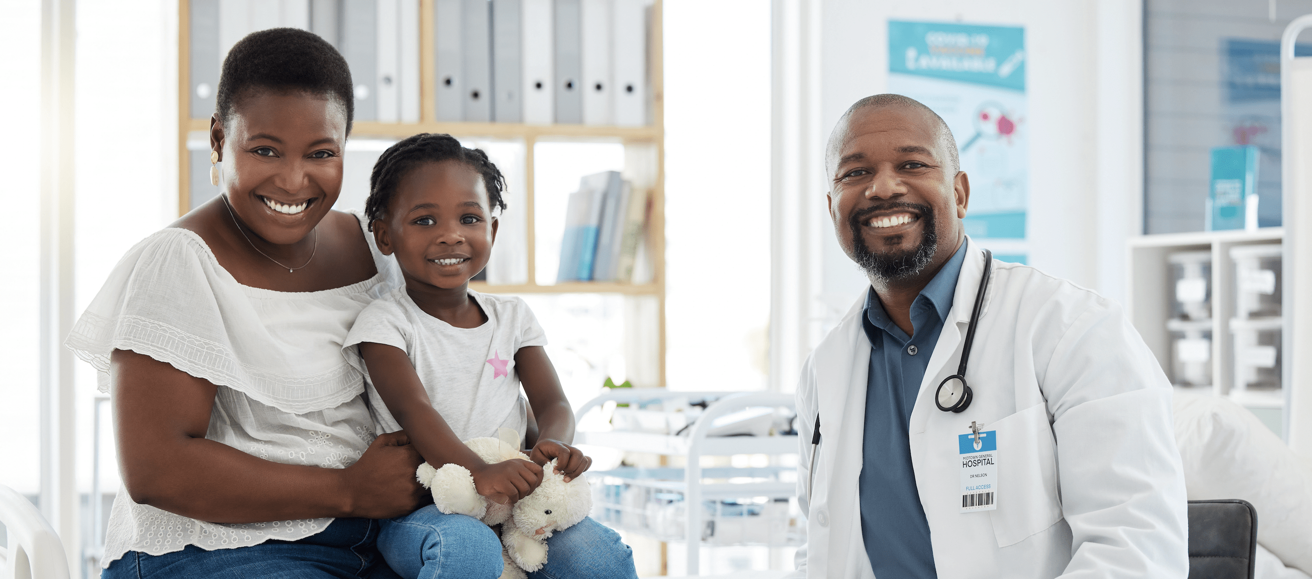 Doctor and patients sitting together in Dr's office smiling
