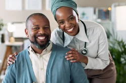 Male patient and doctor standing together for a photo