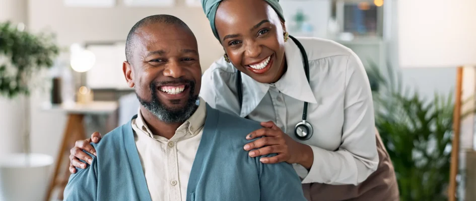Male patient and doctor standing together for a photo