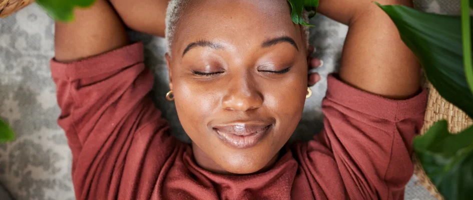 Woman relaxing with arms folded above her head