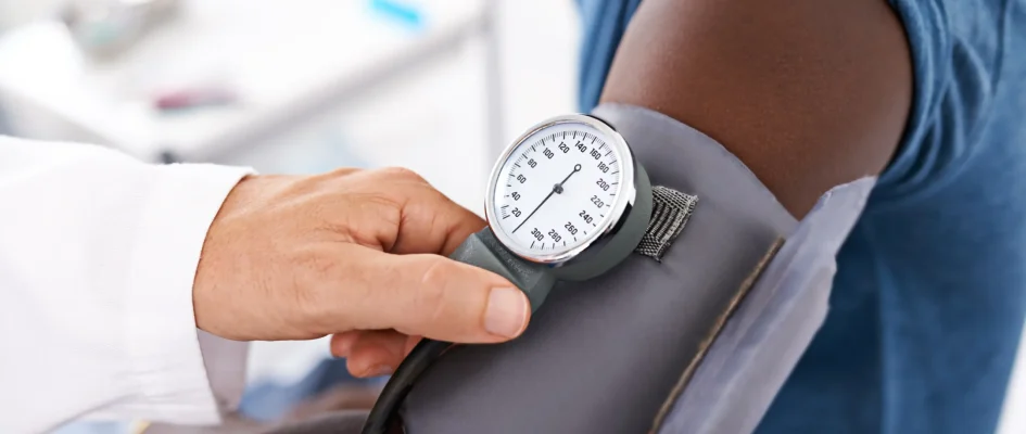 Patient getting their blood pressure checked by doctor