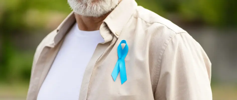 senior man wearing blue-ribbon for prostate cancer