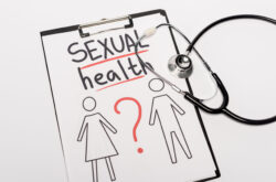 top view of clipboard with sexual health lettering, drawn man and woman near stethoscope isolated on top view of clipboard with sexual health lettering, drawn man and woman near stethoscope isolated on