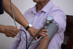 nurse measuring the pulse of the patient blood pressure being checked by health care provider