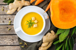 Seasonal spicy fall autumn creamy pumpkin and carrot soup bright orange soup with croutons and ginger