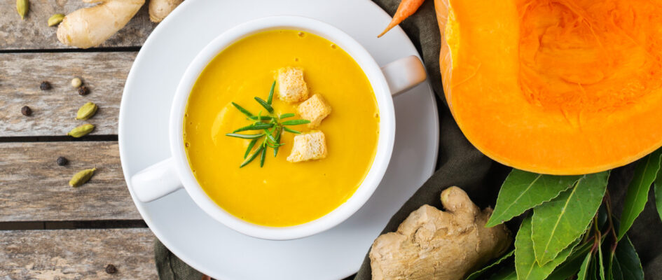 bright orange soup with croutons and ginger