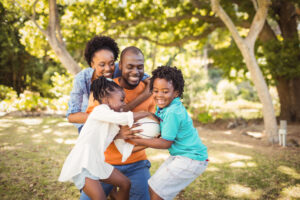 happy family playing with a ball outdoors
