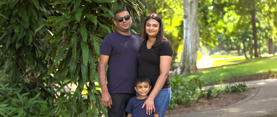 Family Posing Together Infront of Greenery