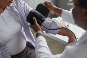 Health professional checking a persons blood pressure