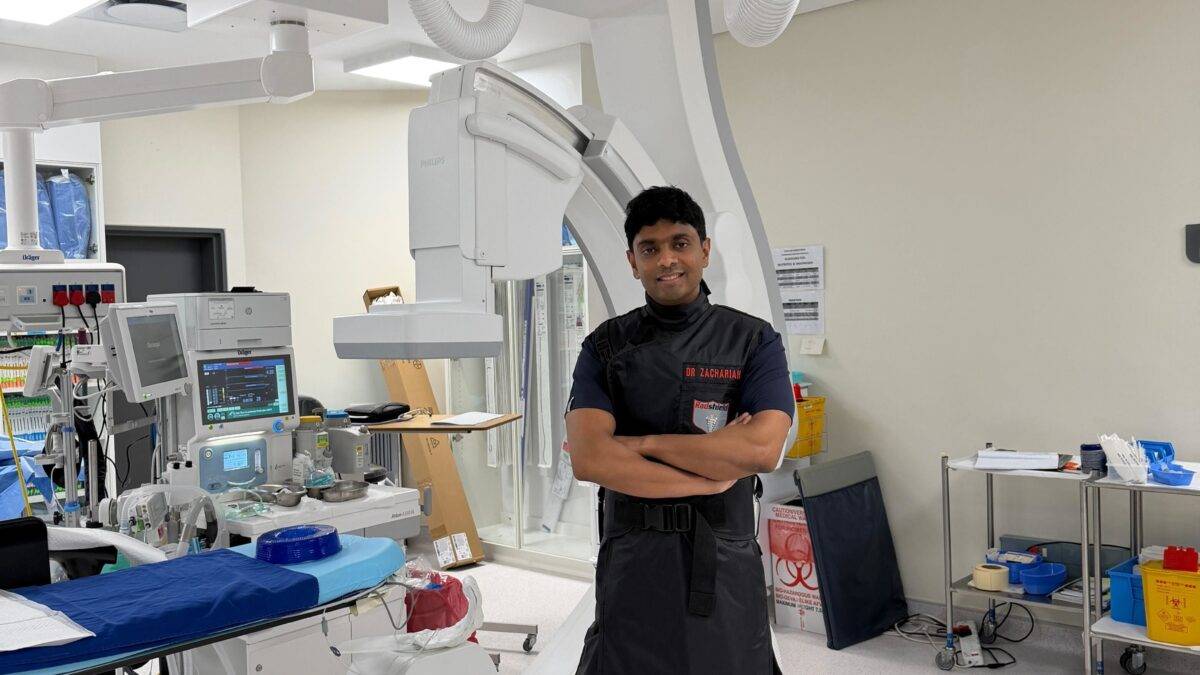 Doctor's assistant standing with his arms crossed in an operating room