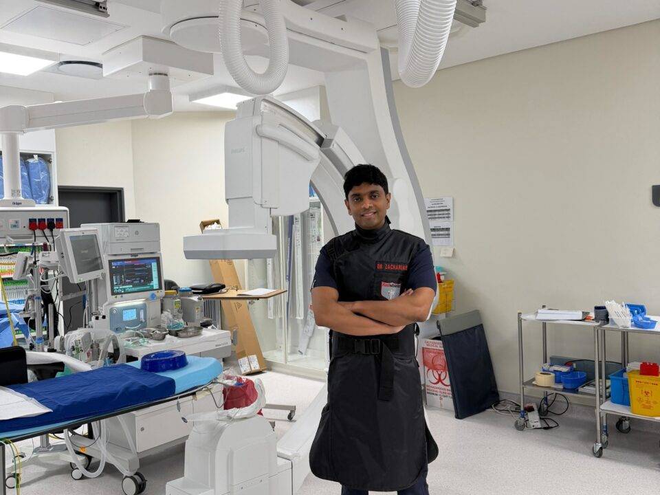 Doctor's assistant standing with his arms crossed in an operating room