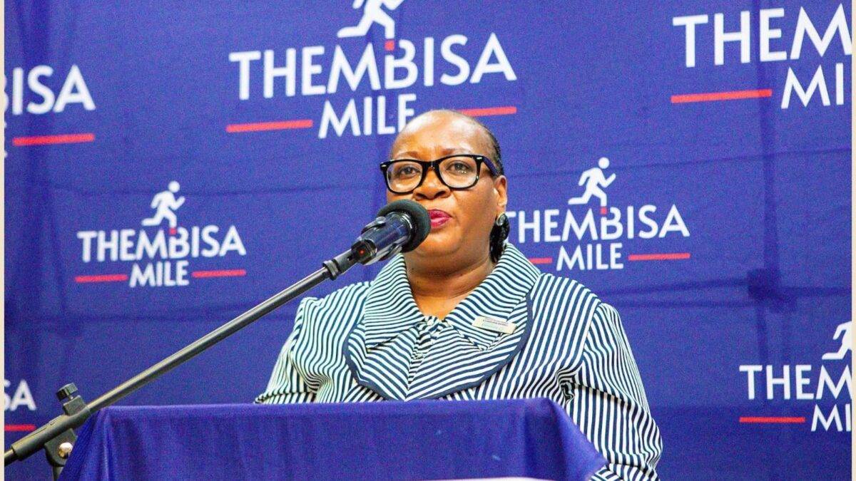 Lady of the Thembisa Mile standing on a podium talking into a microphone