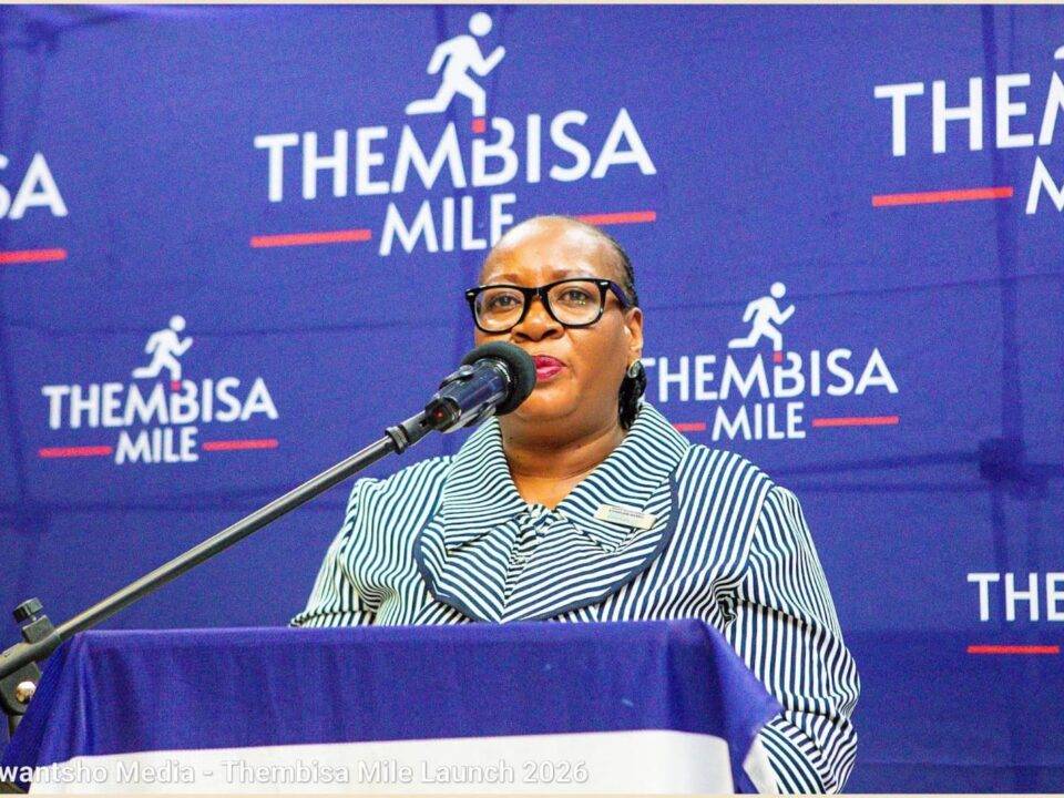 Lady of the Thembisa Mile standing on a podium talking into a microphone
