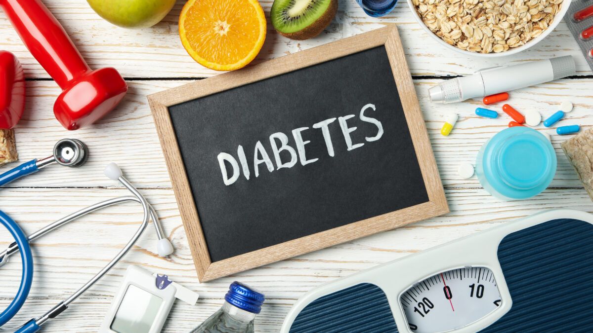 Word Diabetes and diabetic accessories on wooden background