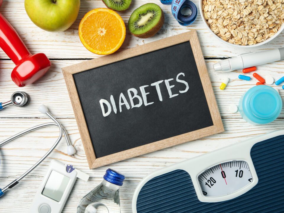 Word Diabetes and diabetic accessories on wooden background