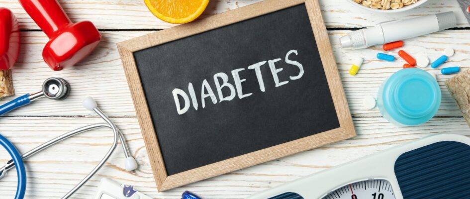 Word Diabetes and diabetic accessories on wooden background