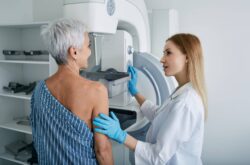 Senior woman having mammography scan at hospital with medical technician. Mammography procedure, breast cancer prevention Senior woman having mammography scan at hospital with medical technician. Mammography procedure, breast cancer prevention