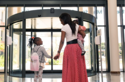 mother and two children walking out of the hospital