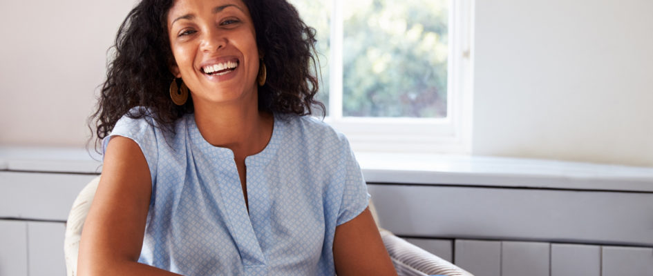 smiling african woman sitting on chair