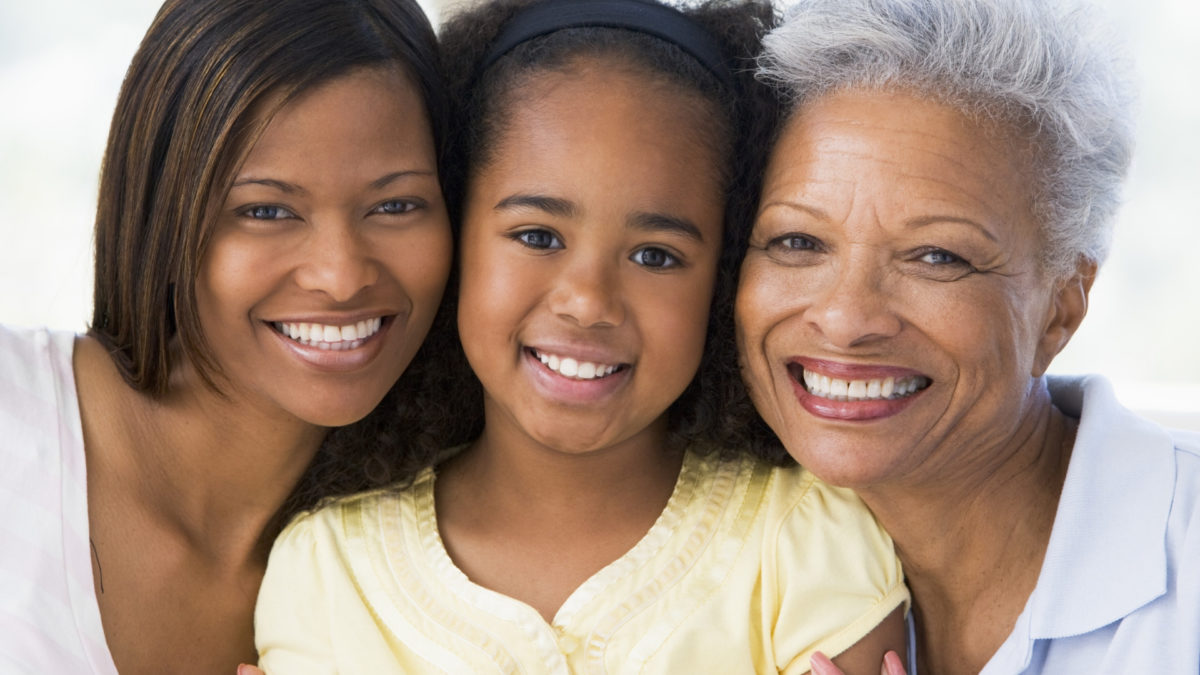 mother, daughter and granddaughter smiling