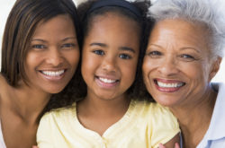 mother, daughter and granddaughter smiling