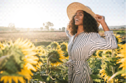 women smiling around sunflowers