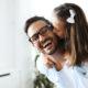 Portrait of father and daughter playing at home together