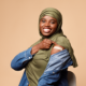 Woman Showing Vaccinated Arm With Bandage After Injection, orange Background