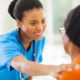 african medical nurse comforting senior patient