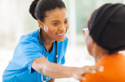 african medical nurse comforting senior patient