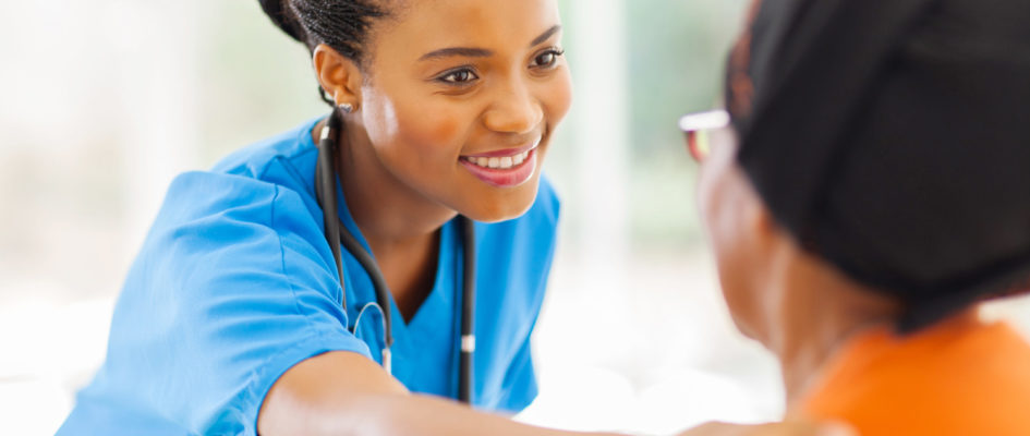 african medical nurse comforting senior patient