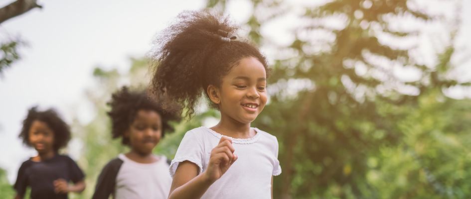 kids running surrounded by trees