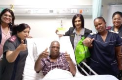 Doctors and nurses smiling with recovering patient