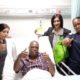 Doctors and nurses smiling with recovering patient