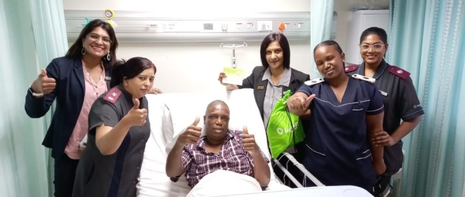 Doctors and nurses smiling with recovering patient