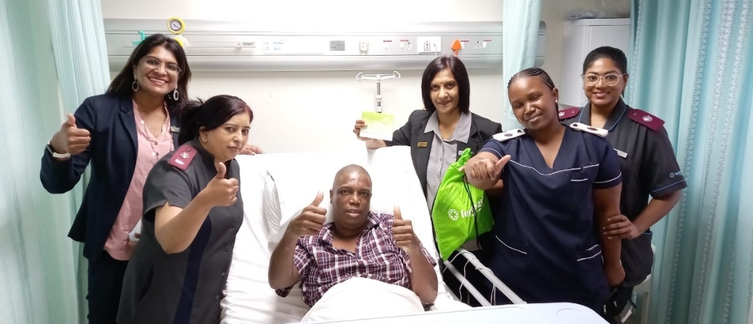 Doctors and nurses smiling with recovering patient