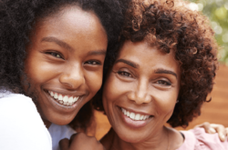 mother and daughter smiling