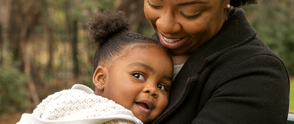 Happy African American mother and her daughter.